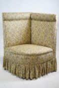 An upholstered corner chair, with padded back and seat ,
