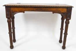 A Victorian oak hall table, the top with hinged cover on turned carved and fluted legs,