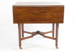 An early 20th century mahogany rectangular Pembroke table the central drawer fitted with three