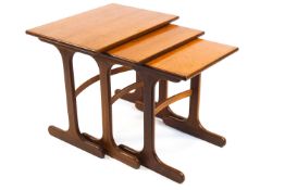 A nest of three G-plan style teak tables, with plain rectangular tops and curved stretchers,