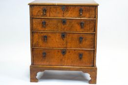 An 18th century walnut small chest of drawers, with moulded front enclosing four graduated drawers,