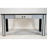 A 1950's white enamel table with black enamel banding and one frieze drawer on square legs,