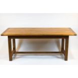 A rectangular farmhouse table, the oak top on base with chamfered rectangular feet,