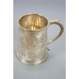 A small silver mug, of plain tapering cylindrical form, with a scroll handle, London 1936, 9cm high,