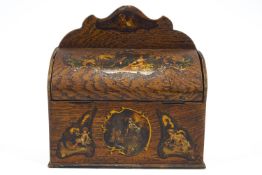 An oak letter rack printed with vignettes in French style the arched back above a hinged cover,