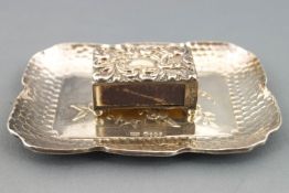 A shaped rectangular silver pin tray with lobed edging over spot hammered decoration,