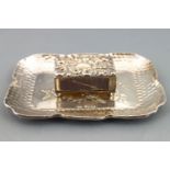 A shaped rectangular silver pin tray with lobed edging over spot hammered decoration,