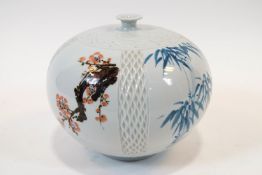 A Japanese porcelain vase of melon form with incised work and panels decorated with bamboo,