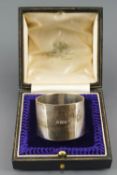 A cased heavy gauge silver napkin ring, of plain flat cylindrical form, London 1924, 3cm diameter,