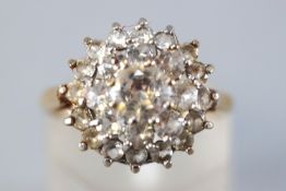 A yellow metal three tier cluster ring set with colourless cubic zirconia.