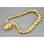 A yellow metal bracelet in the design of a snake.