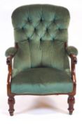 A Victorian button back armchair, with scrolled arm rests and upholstered in sea green velvet,