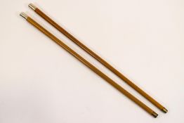 A pair of malacca walking canes with foreign silver mounts,