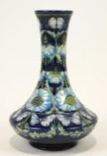 A Moorcroft 'Pavior' vase, flared rim to slender neck and bulbous lower body,