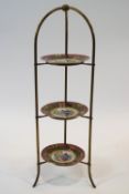 A brass three-tiered cake stand,