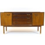A G-Plan mid 20th century teak sideboard with two hinged cupboards and three central drawers,
