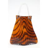 A Murano style opaque glass model of a handbag with clear strap handles,