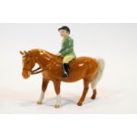A Beswick porcelain equestrian figure of a child on horseback,