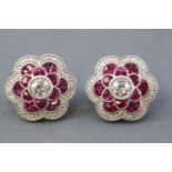 A pair of white metal cluster stud earrings.