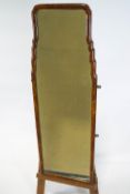 A full length wall mirror, with shaped walnut frame,
