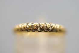 A yellow metal half hoop ring. Set with five old European/single cut diamonds.