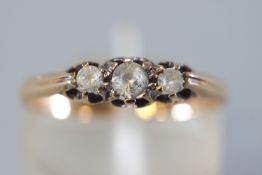 A yellow metal three stone ring set with cubic zirconia. Hallmarked 9ct gold, Birmingham, 1962.