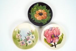 Three Moorcroft small dishes, comprising a 'Magnolia', 'Poppy' and 'Apple Blossom', pattern example,