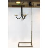A three branch candle stand, suspended from an arched frame with rectangular base,