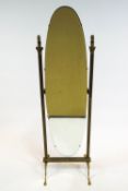 A brass mounted cheval mirror, the oval bevelled hinged mirror flanked by brass corinthian columns,