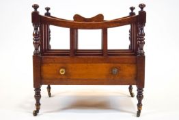 A mahogany 19th century Canterbury, with concave top and four divisions over a single drawer,