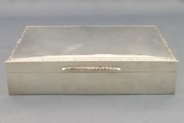 A silver cigarette box, of strict plain rectangular form,