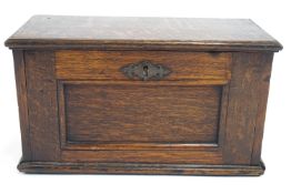 An oak small rectangular Collector's cabinet, the hinged fall front panelled lockable front,