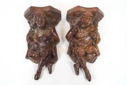 A pair of moulded terracotta corbels/wall brackets, each in the form of Medieval musicians,