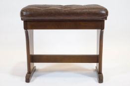 A Wurlizter wooden piano stool, 20th century, with hinged leatherette seat,