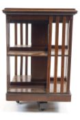A mahogany revolving bookcase, the edged top inlaid with spandrels of oak leaves and acorns,