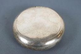 A silver pinch action tobacco/snuff box, of plain round form, Chester 1898, 8cm wide,
