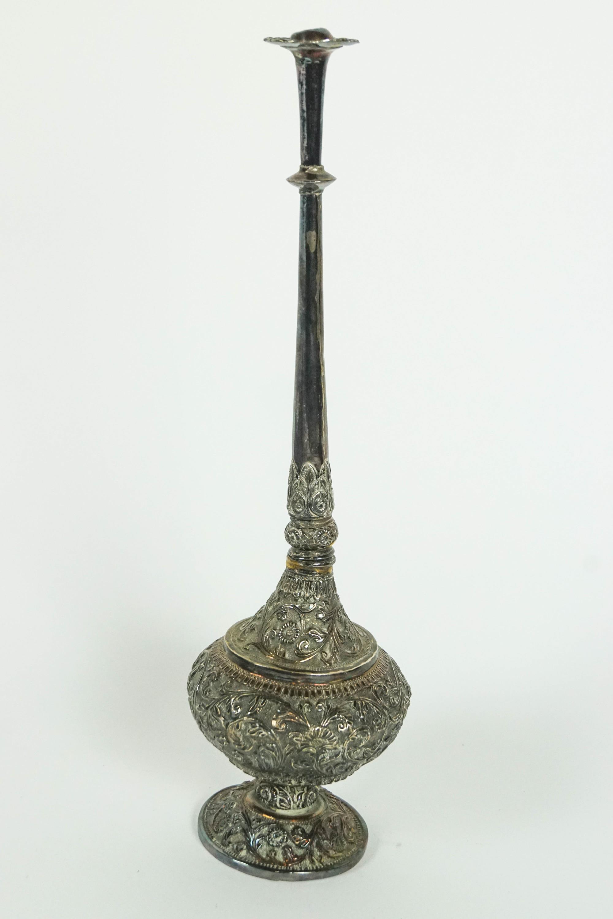 An Asian white metal rosewater casting bottle of usual form,