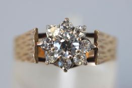 A yellow metal cluster ring set with colourless cubic zirconia.