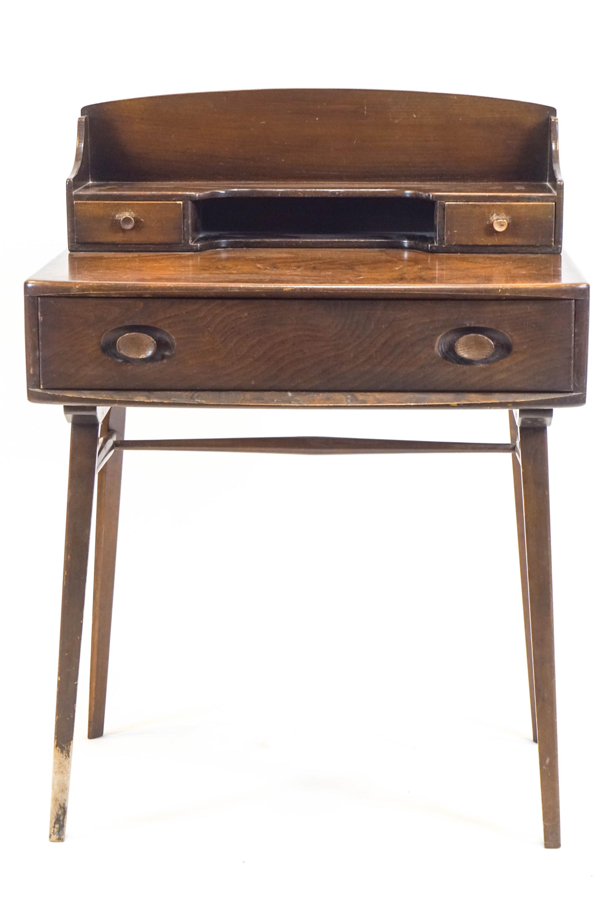 An Ercol elm desk the raised back with two drawers above one long drawer, on square tapering legs,