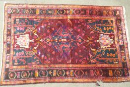 A handmade Persian Lori carpet, circa 1930-1950, with a central lozenge on a dark ground,