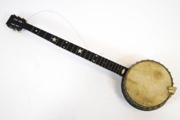 A banjo by C Boileau inlaid with mother of pearl stars and dots