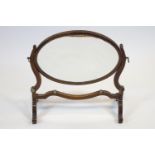A 19th century mahogany dressing table mirror, the oval mirror plate in mahogany swing frame,