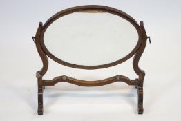 A 19th century mahogany dressing table mirror, the oval mirror plate in mahogany swing frame,