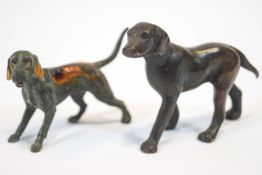 A brass figure of a dog with bronze patination,