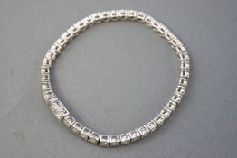 A white metal line bracelet.