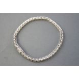 A white metal line bracelet.