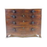 A Victorian mahogany bow fronted chest of four long drawers with turned wooden handles,