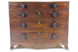 A Victorian mahogany bow fronted chest of four long drawers with turned wooden handles,