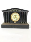 An early 20th century cast iron and brass mounted mantel clock, the case of architectural form,