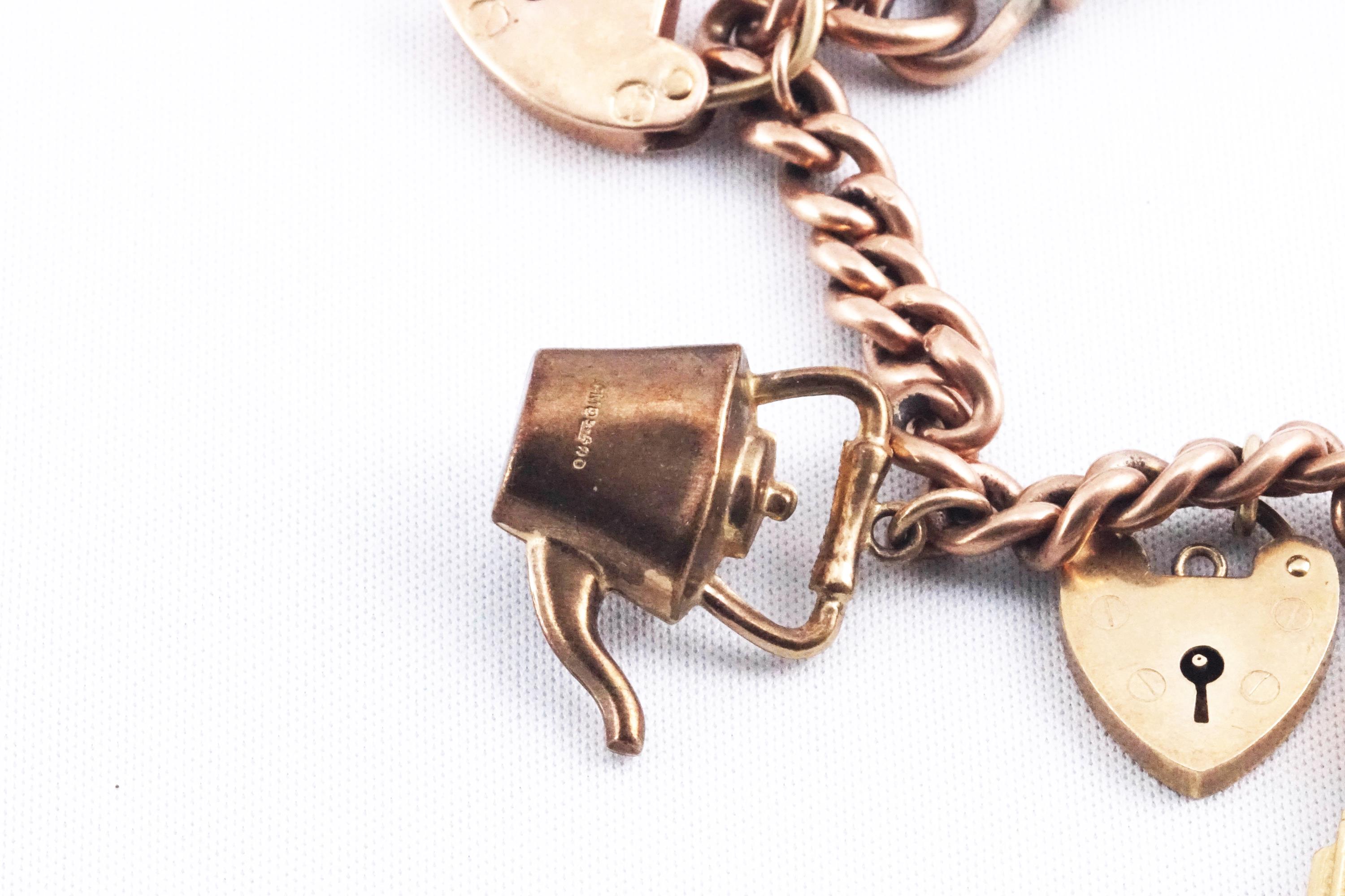 A rose gold curb link charm bracelet with padlock and safety chain having six assorted charms - Image 3 of 3